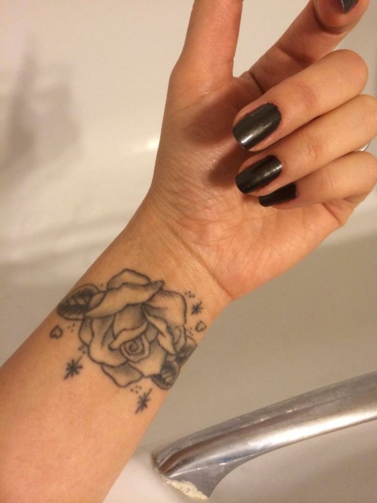 tattoo of a rose on the wrist