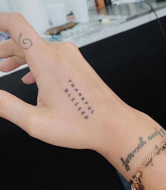 phrase tattoo on hand