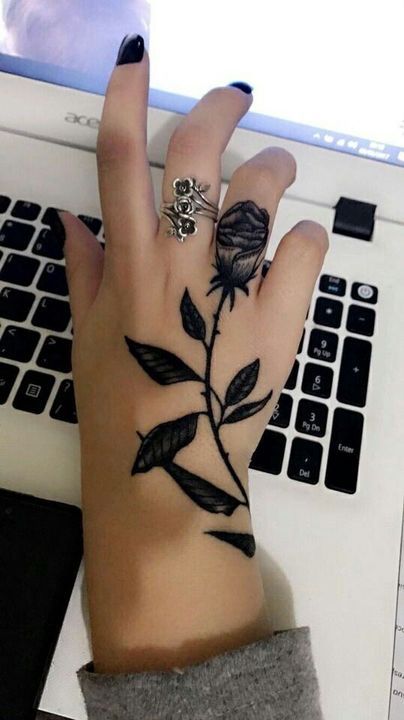 rose tattoo on hand