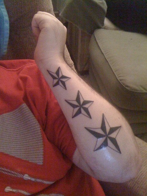 Three star design on the arm