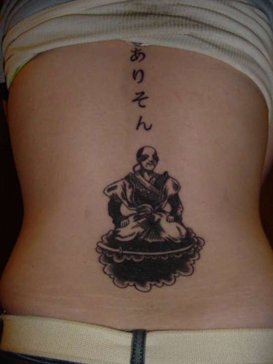 Several Japanese characters and a monk with samuri sword tattooed along the back