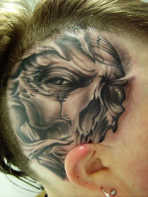 For the most daring, this person has tattooed a ttricate skull on one side of the head over the ear