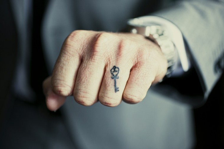 small tattoos-man-key-finger