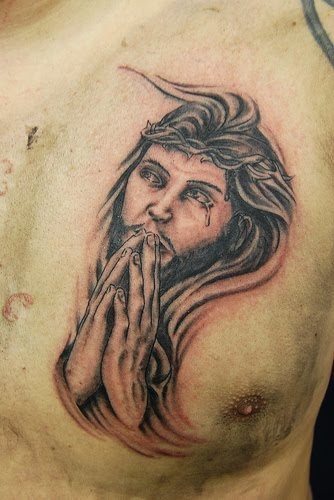 Tattoo of the Son of God praying, on this occasion to the traditional beard, hair and long characteristic of Jesus Christ, they have added their hands in prayer position and tears that fall on their eyes