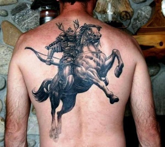 Warrior on his horse tattooed on the back