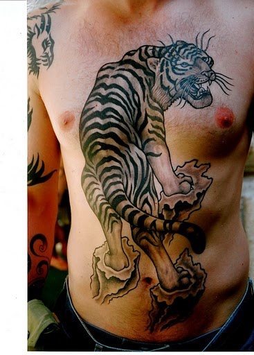 Great design of a tiger with its back tattooed across the chest