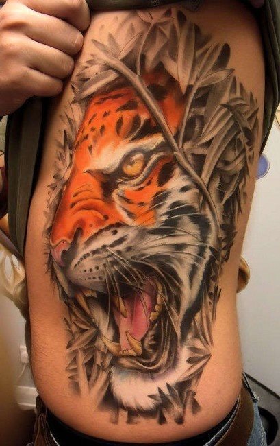 Excellently done this tattoo on the side of the head of an angry tiger showing his fangs