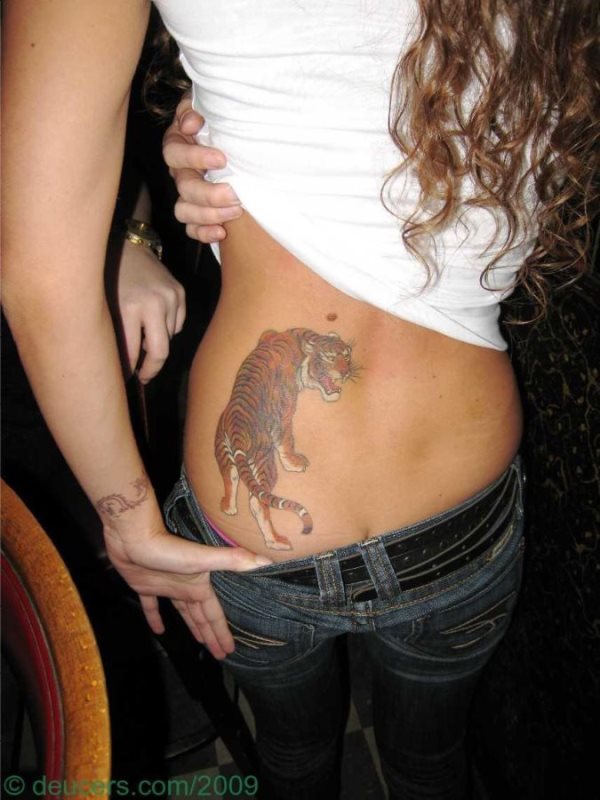 This girl wears her tiger tattoo in the lower back