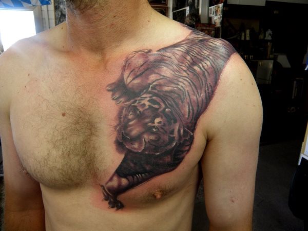 Nice design of a tiger that comes out of this boy's shoulder