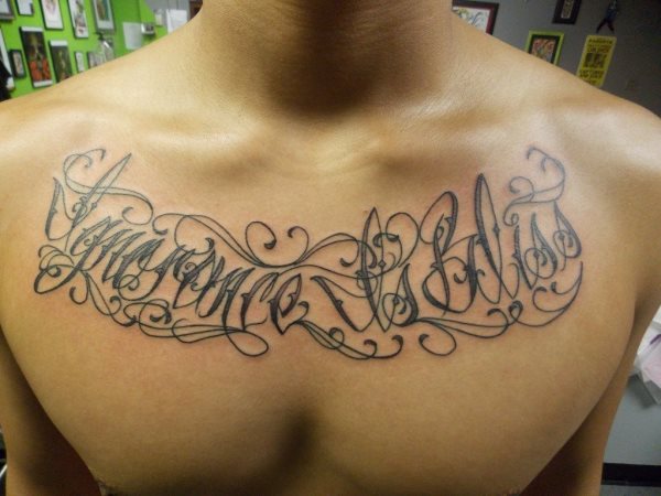 Tattoo on the chest that we do not like too much because too many borders have been tattooed around and on the words that have been tattooed on the chest, preventing these words from being seen clearly, together forming a poorly readable scribble